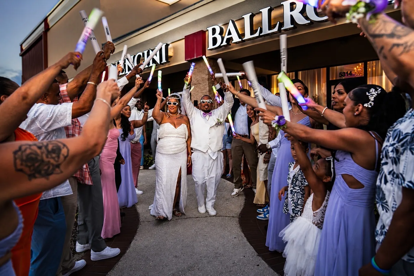 Real newlyweds leaving Nencini Ballroom through a cheering corridor of their guests