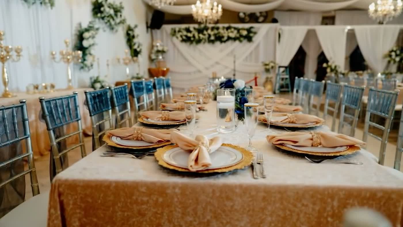 Reception table set with gold chargers and floating candles at Nencini Ballroom