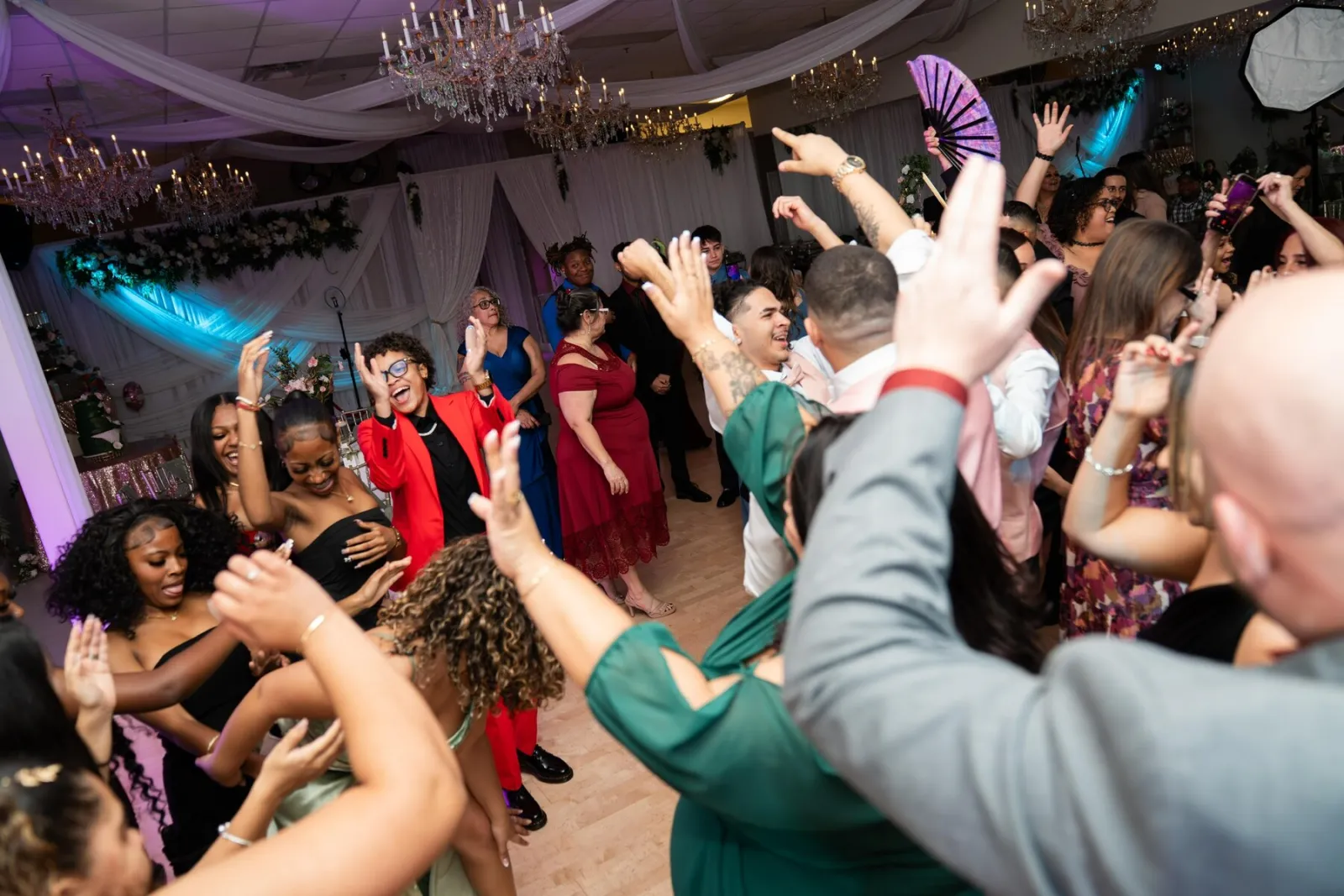 Dance production energy at Nencini Ballroom with guests celebrating on the dance floor under chandelier lighting