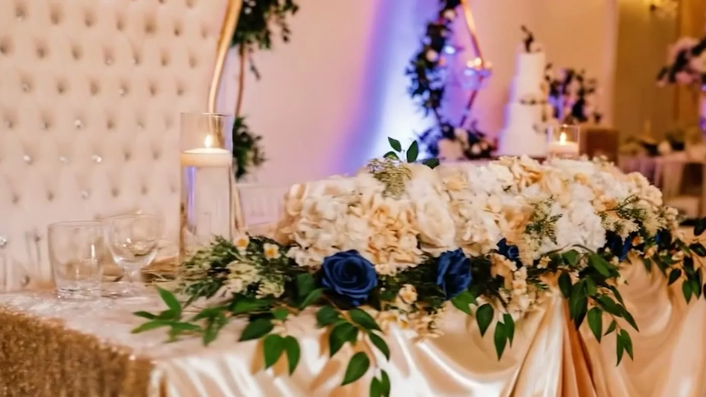 Wedding sweetheart table with ivory and navy florals at Nencini Ballroom