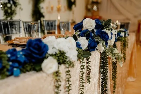 Blue and white floral detail on a dressed reception table inside Nencini Ballroom