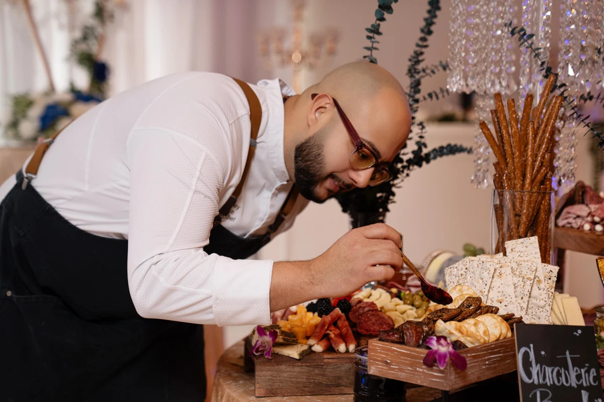 A guest enjoying the charcuterie display at Nencini Ballroom