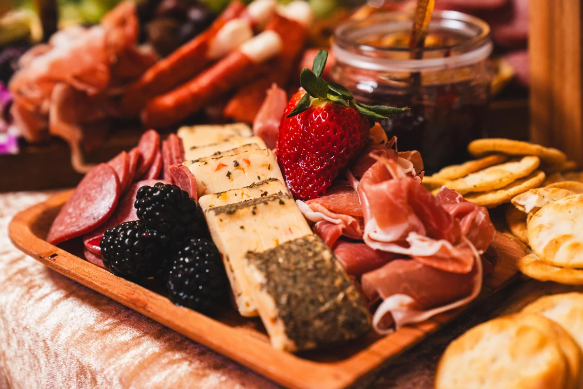 Charcuterie board with sliced meats, cheese and berries