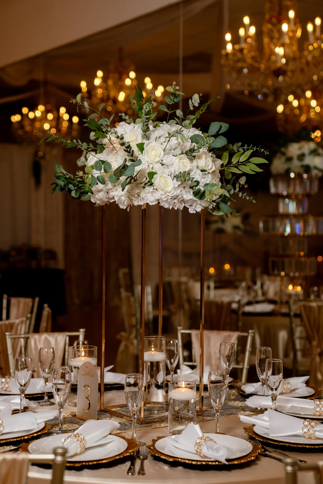 Candlelit tables and flowers in the ballroom